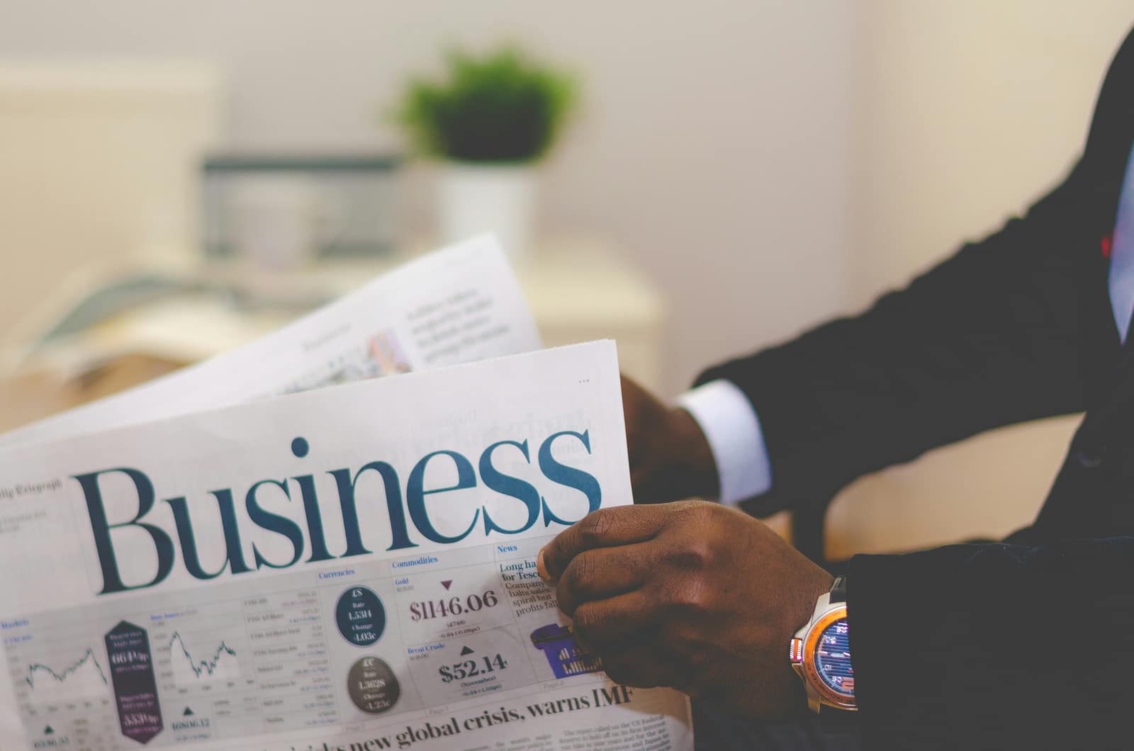 A person reading the market pages of a business newspaper